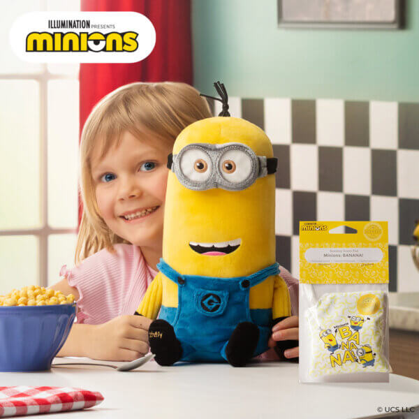 Stylized picture of girl in a cafe holding minion Kevin with a scent package